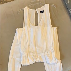 White sleeveless open back jumpsuit w pockets.